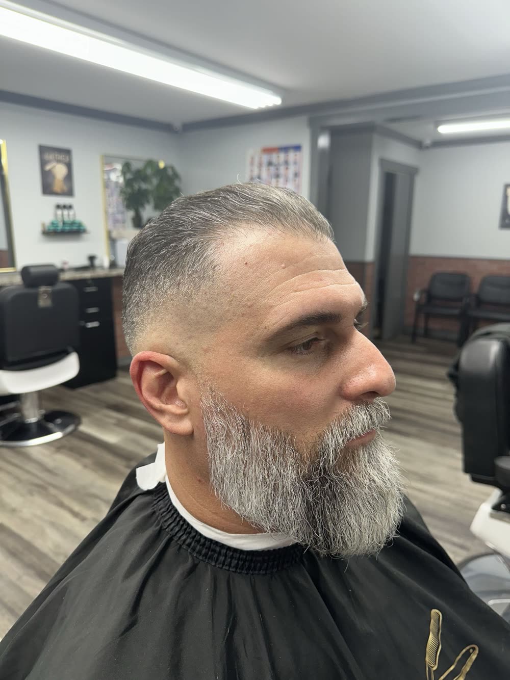 Distinguished grey beard sculpt with a clean fade